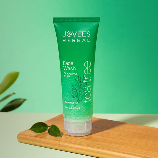 Jovees Natural Tea Tree Clearing Face Wash for acne-prone skin by Sutrakart on a wooden surface.