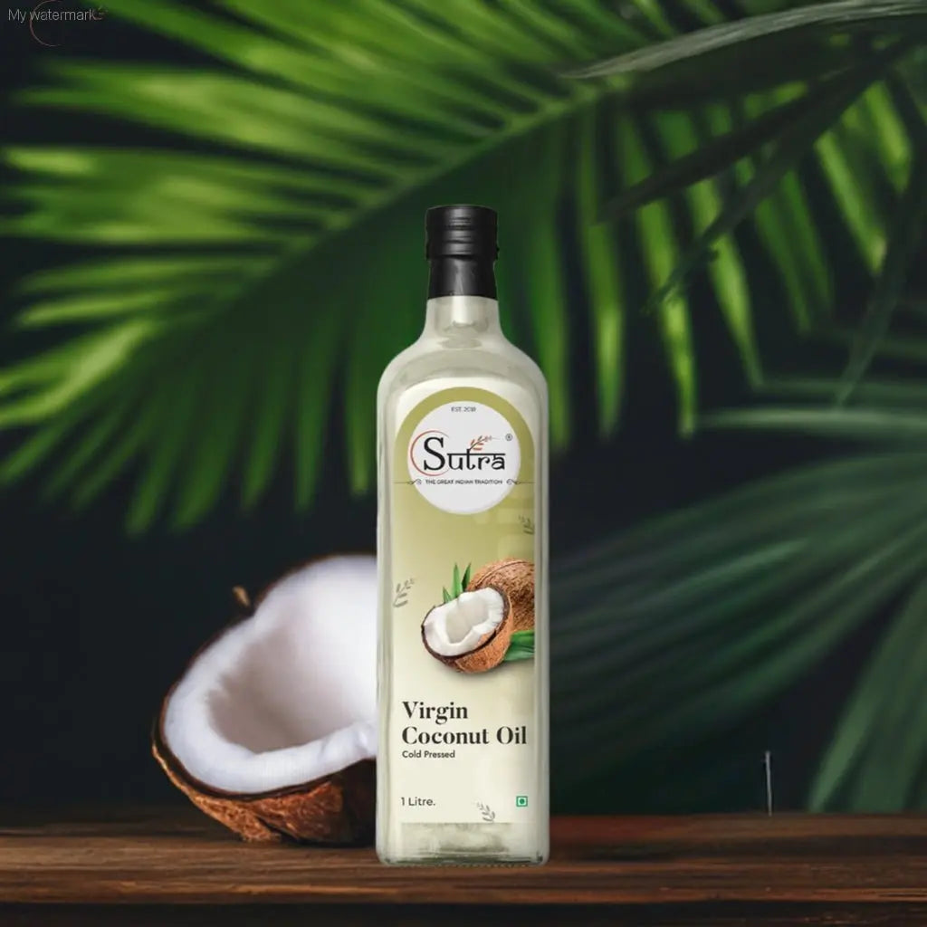 Sutra Wood Cold Pressed Virgin Coconut Oil bottle in front of coconuts and green leaves, emphasizing cold-pressed and wood-pressed qualities.