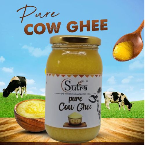 Pure Sutra Cow Ghee jar with grass-fed cows in the background, highlighting its natural and healthy quality for cooking.